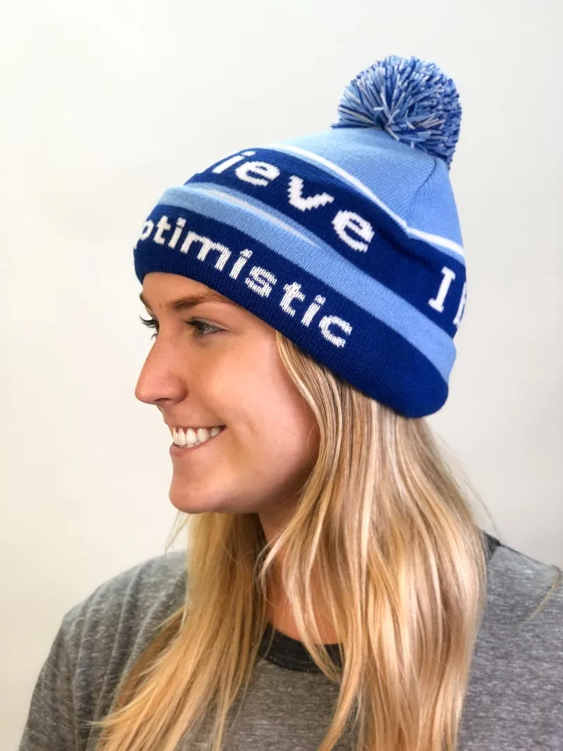 I believe™ blue knit beanie with I am optimistic™ on inside cuff