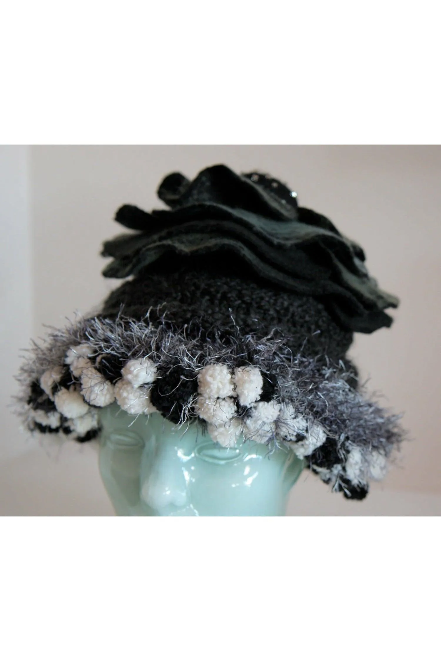 Whimsical black with white and gray hand knit and felt flower hat.