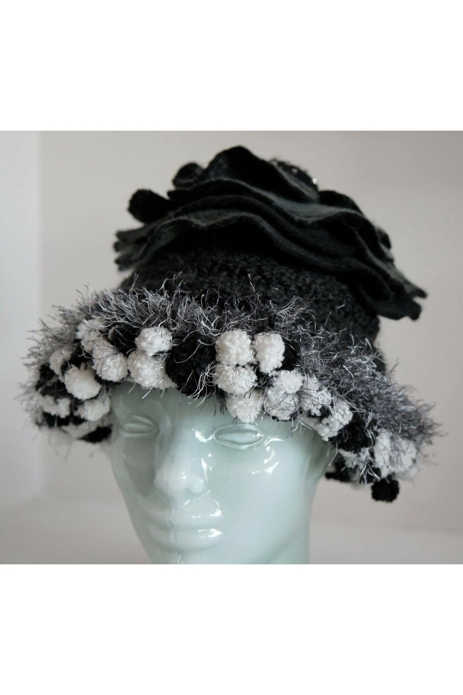 Whimsical black with white and gray hand knit and felt flower hat.